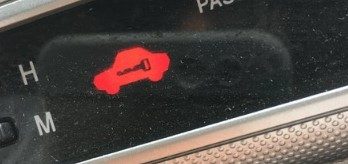 What does Car With Key Warning Symbol colors of red mean